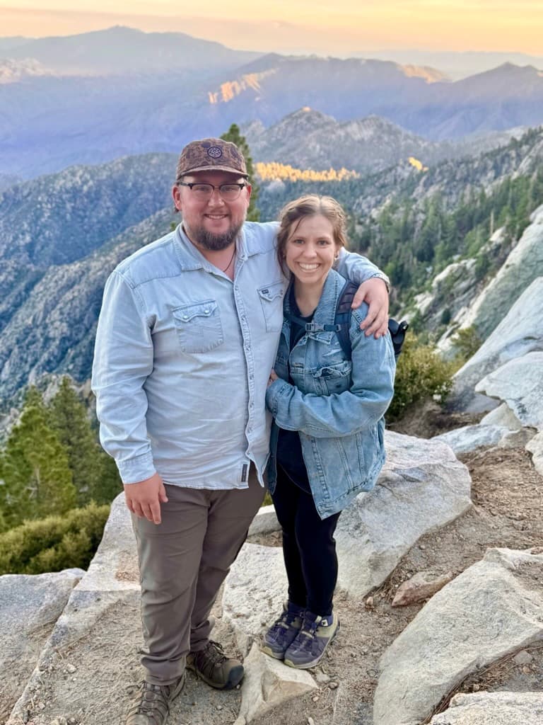 Kate and Matt standing together on a rocky mountain overlook.
